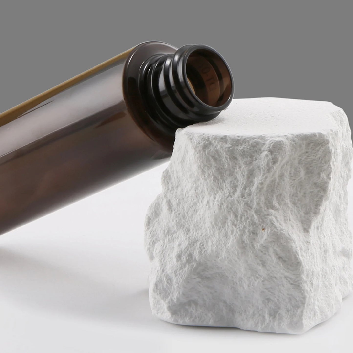 coffee bean water spray bottle with a sleek design placed on a white rock surface
