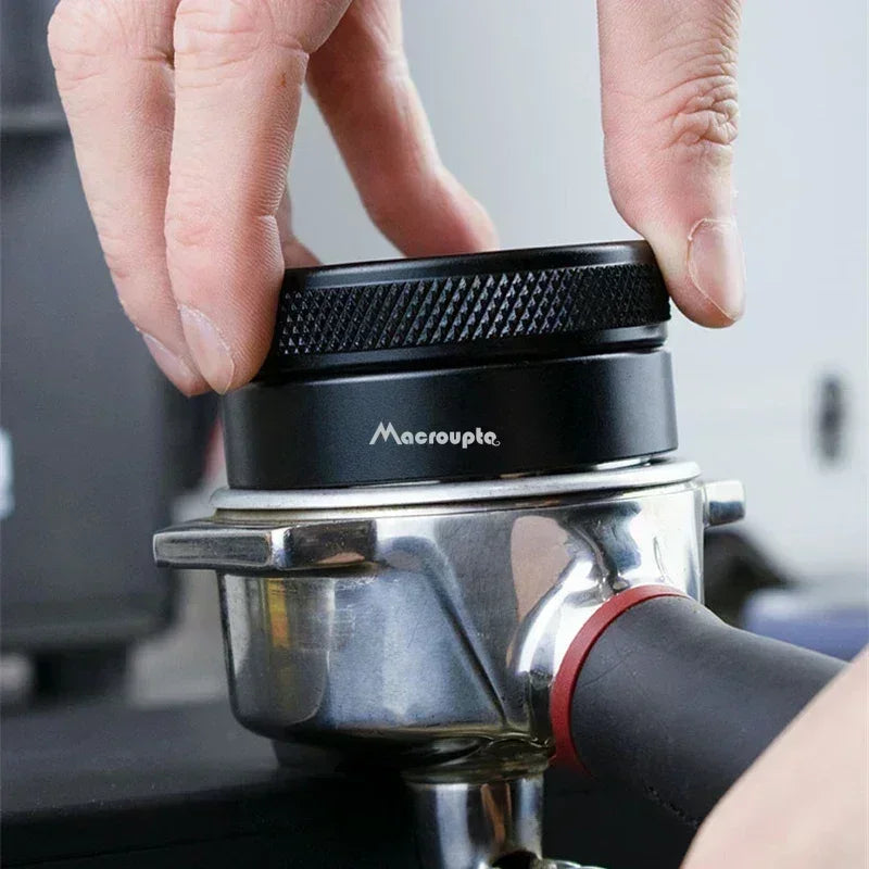 Hand adjusting the My Store adjustable espresso distributor on a portafilter for precise coffee tamping