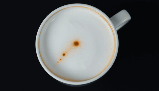 Close-up of a creamy frothing alternative milks coffee with a smooth foam texture