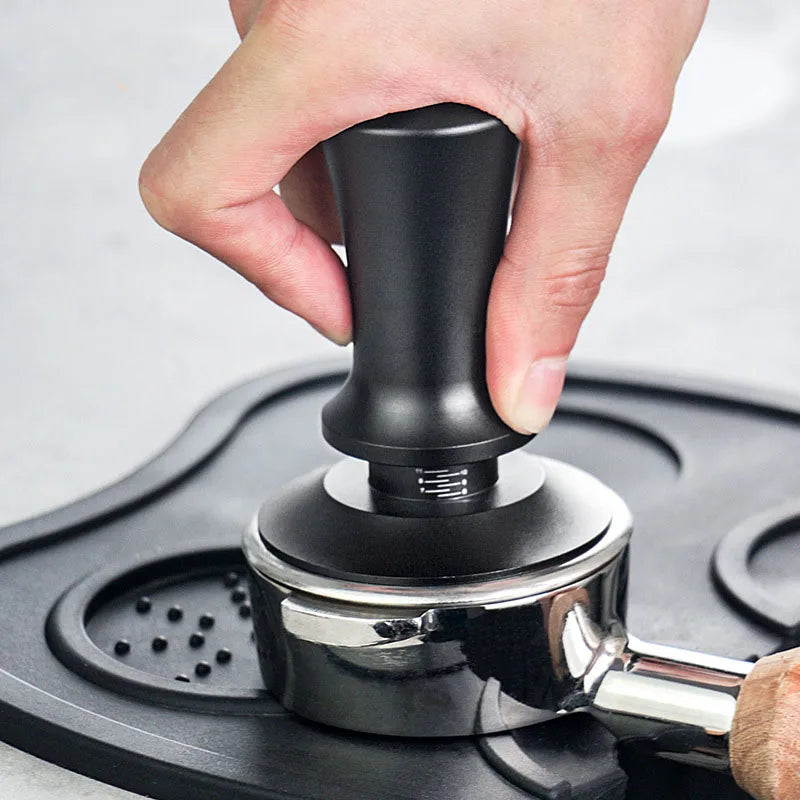 Premium coffee tampers being used to create a perfect espresso puck for rich flavor and crema