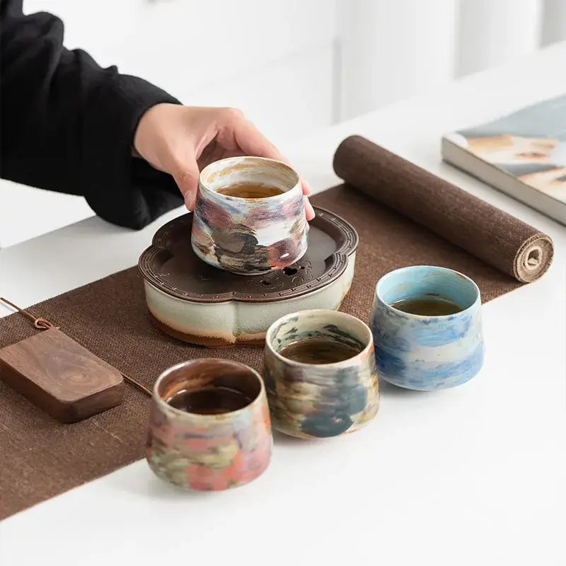 Set of four hand crafted espresso cups in various colors, perfect for serving espresso at home
