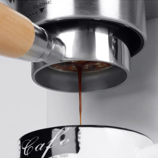 51mm bottomless portafilter Delonghi by UK Espresso with espresso shot dripping into coffee cup