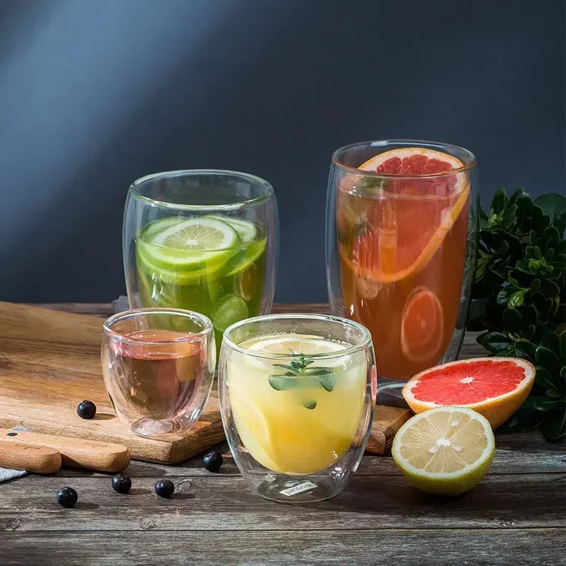 UK Espresso double wall glass coffee mugs filled with citrus and herbal drinks on wooden table