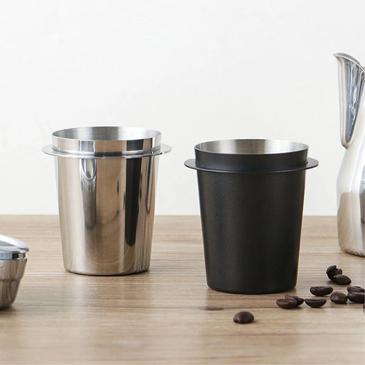Two stainless steel espresso dosing cups, one silver and one black, perfect for barista use